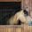 A horse looking out of the window of a stable